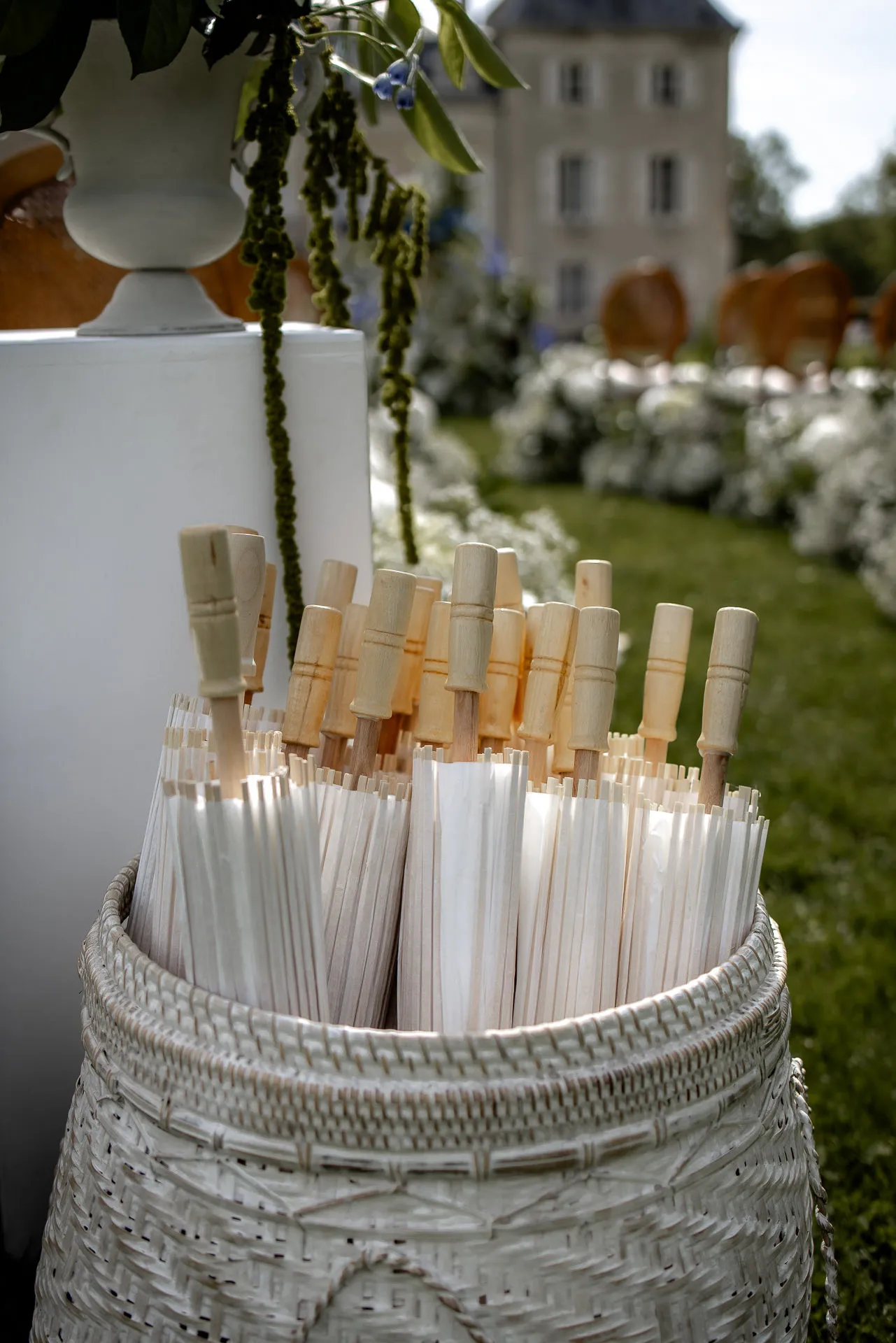 Elegant wedding ceremony details at Chateau de Varennes with parasols for the outdoor ceremony in France